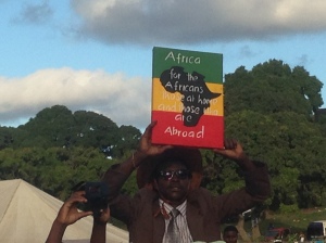 A DRC refugee holds up a sign in protest, during a visit by SA president Jacob Zuma to a xenophobia displacement camp in Durban.